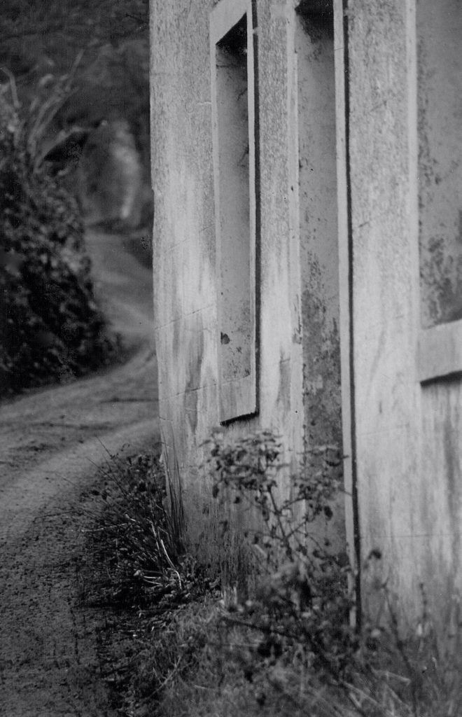Close-up of the facade of Chapel House Farm, Gilcrux, with the lonning to Tallentire Hill visible beyond